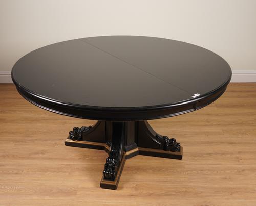 RALPH LAUREN; A BLACK LACQUER CIRCULAR EXTENDING DINING TABLE ON LION’S PAW PEDESTAL