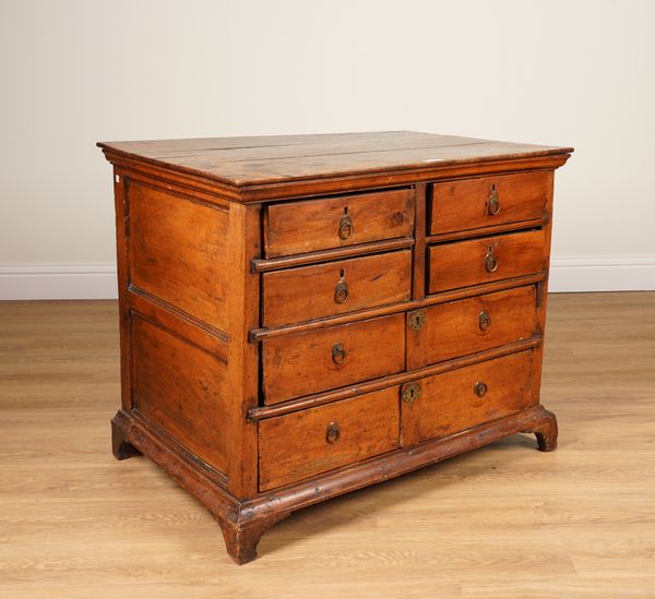 AN EARLY 18TH CENTURY FRENCH OAK AND WALNUT CHEST OF DRAWERS