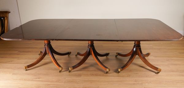 A REGENCY STYLE MAHOGANY TRIPLE PILLAR EXTENDING DINING TABLE