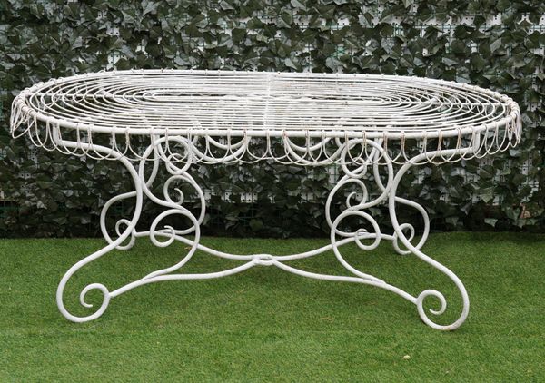 A 20TH CENTURY WHITE PAINTED OVAL WIREWORK GARDEN TABLE