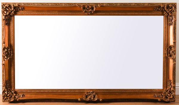 A MODERN GILT FRAMED BEVELLED GLASS MIRROR WITH FLORAL MOULDED FRAME