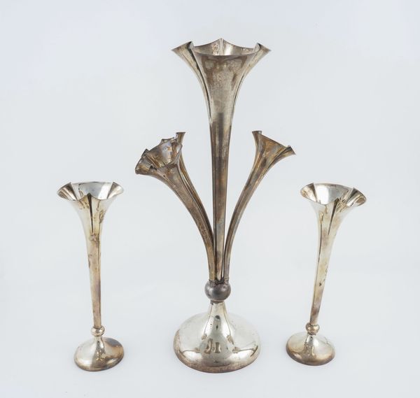 A SILVER COMPOSITE GARNITURE OF TRUMPET SHAPED VASES (3)