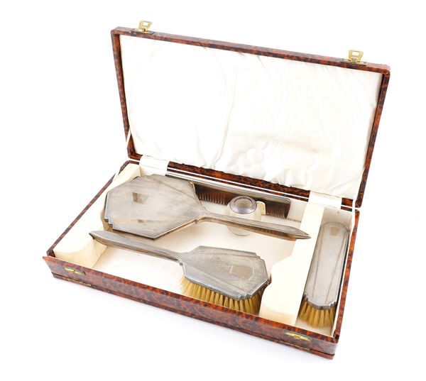 A LADY'S SILVER MOUNTED FOUR PIECE DRESSING SET AND A SILVER RIMMED GLASS MATCH STRIKING STAND (5)