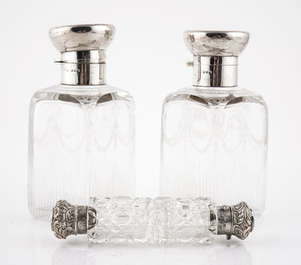 A PAIR OF SILVER MOUNTED RECTANGULAR GLASS SCENT BOTTLES AND ANOTHER SCENT BOTTLE (3)