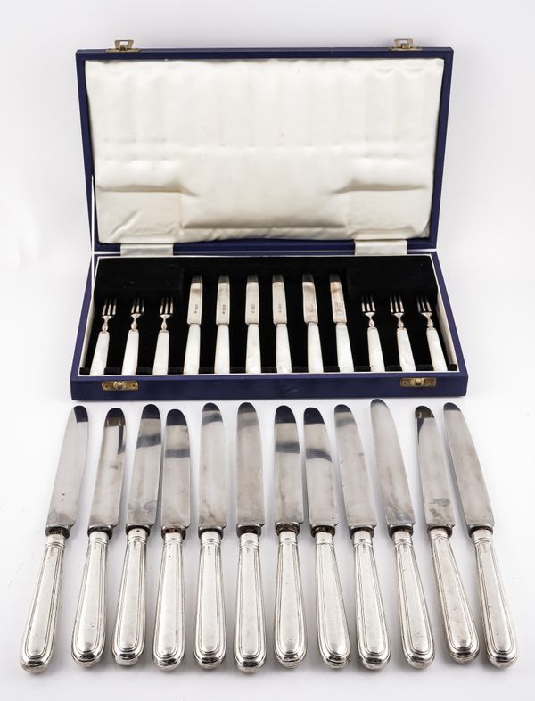 A SET OF SIX PAIRS OF SILVER DESSERT KNIVES AND FORKS HAVING MOTHER-OF-PEARL HANDLES AND FURTHER KNIVES