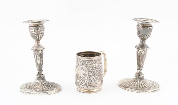 A LATE VICTORIAN SILVER CHRISTENING MUG AND A PAIR OF SILVER CANDLESTICKS (3)