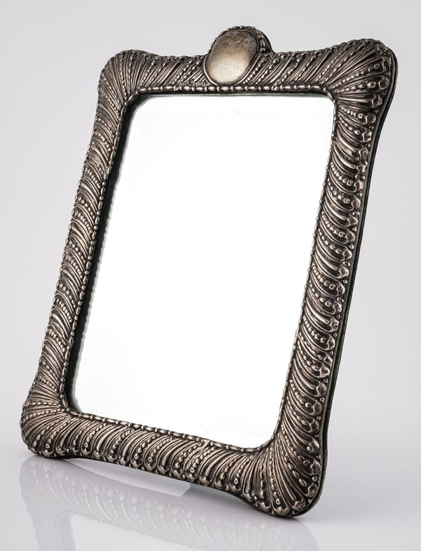 A VICTORIAN SILVER MOUNTED SHAPED RECTANGULAR STRUT BACKED MIRROR