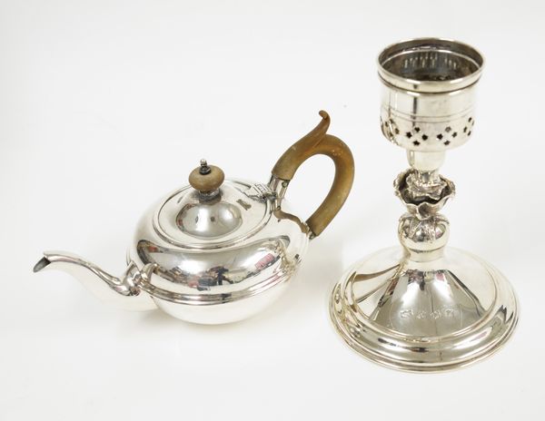 A SILVER STORM CANDLESTICK AND A SILVER TEAPOT (2)