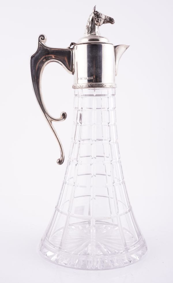 A SILVER MOUNTED FACETED GLASS CLARET JUG