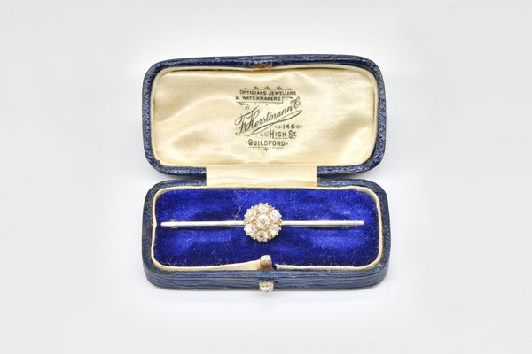 A DIAMOND SEVEN STONE CLUSTER BAR BROOCH