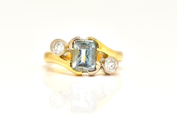 AN AQUAMARINE AND DIAMOND THREE STONE RING