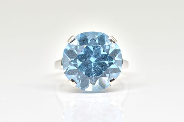 A WHITE GOLD AND SYNTHETIC BLUE SPINEL SOLITAIRE RING