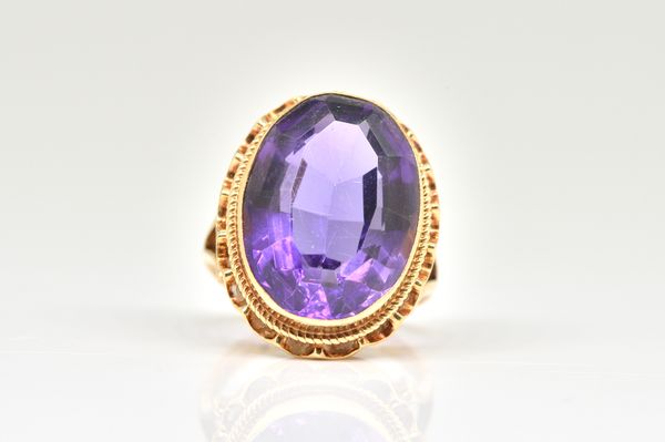 A 9CT GOLD AND AMETHYST SINGLE STONE RING