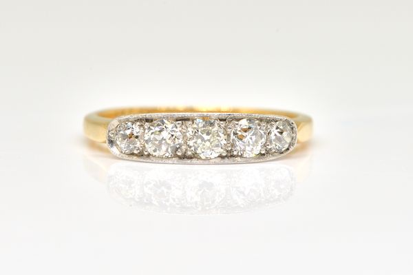 A GOLD AND PLATINUM, DIAMOND SET FIVE STONE RING