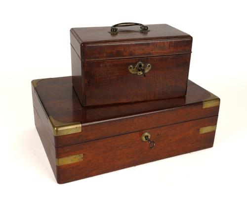 A GEORGE III MAHOGANY TEA-CADDY TOGETHER WITH A BRASS MOUNTED MAHOGANY WRITING SLOPE (2)