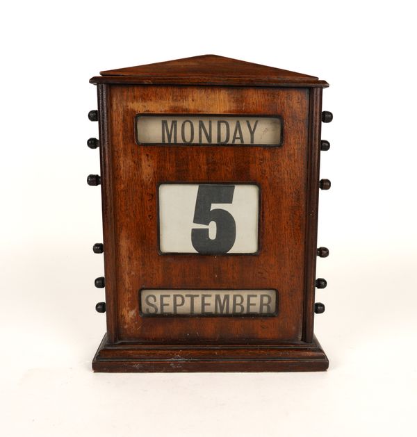 A MAHOGANY PERPETUAL DESK CALENDAR