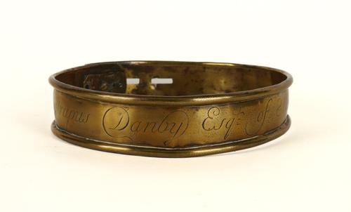 AN ENGLISH BRASS DOG COLLAR ENGRAVED ‘ABSTRUPUS DANBY ESQ OF MASHAMSHIRE 1735’