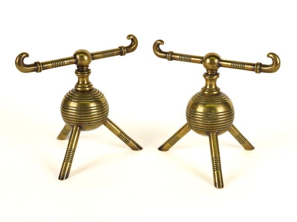 STYLE OF CHRISTOPHER DRESSER: A PAIR OF BRASS AESTHETIC MOVEMENT TRIPOD BASE FIREDOGS (2)