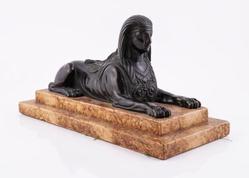 A BRONZE MODEL OF A SPHINX