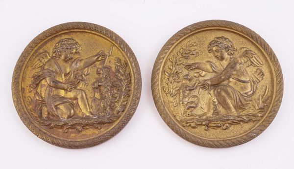 A PAIR OF EMPIRE SMALL GILT-METAL CIRCULAR CLASSICAL PLAQUES OF PUTTI (2)