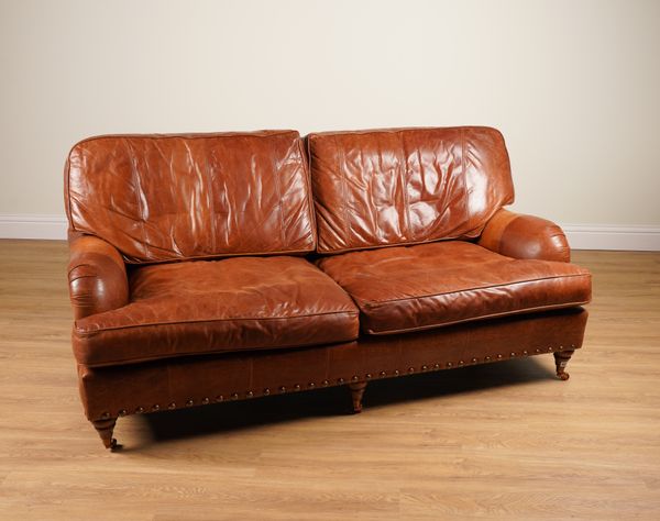 A MODERN STUDDED BROWN LEATHER UPHOLSTERED THREE SEATER SOFA (2)