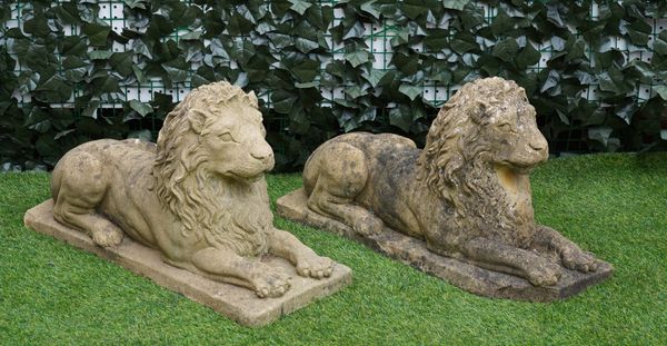 A PAIR OF RECONSTITUTED STONE FIGURES OF RECUMBENT LIONS (2)