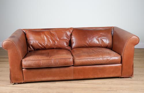 HEALS; A TAN LEATHER UPHOLSTERED THREE SEATER SOFA