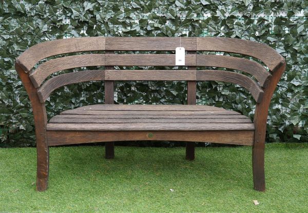 A SLATTED OAK CURVED GARDEN BENCH