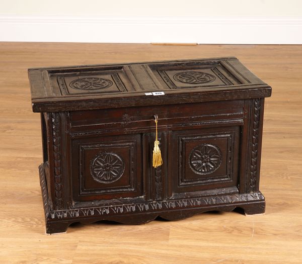 A SMALL 17TH CENTURY CARVED OAK PANELLED COFFER