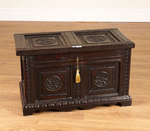 A SMALL 17TH CENTURY CARVED OAK PANELLED COFFER