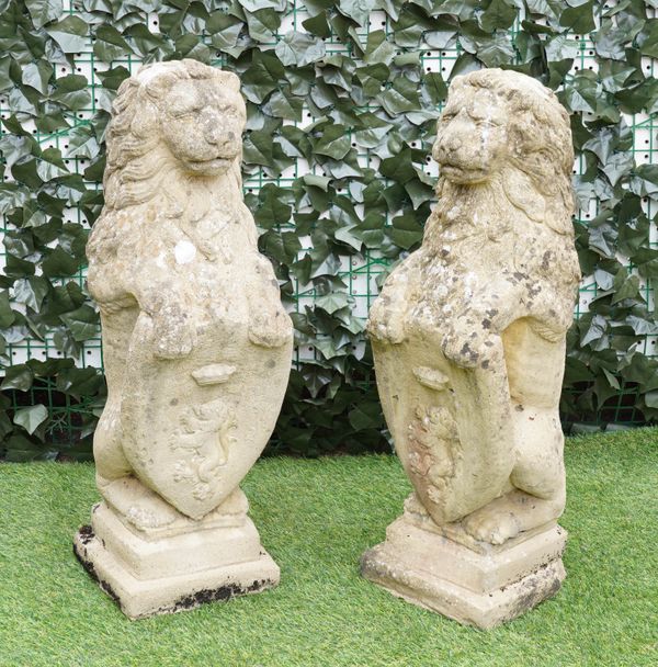 A PAIR OF RECONSTITUTED STONE FIGURES OF SEJANT LIONS (2)