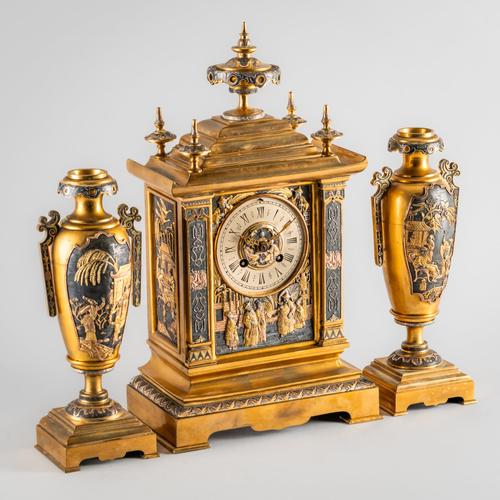 A FRENCH GILT METAL AND PATINATED GARNITURE