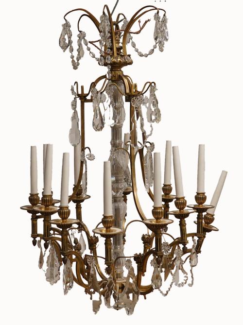 A LOUIS XV STYLE CARTOUCHE SHAPED METAL AND GLASS  TWELVE LIGHT CHANDELIER