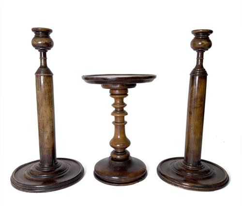 A GEORGE III YEW WOOD BALUSTER TURNED CANDLE STAND AND A PAIR OF TREEN WEIGHTED CANDLESTICKS (3)