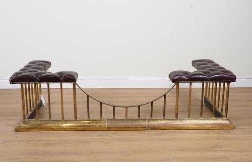 A BRASS AND BURGUNDY RED LEATHER BUTTON-DOWN CLUB FENDER