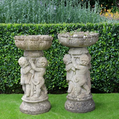 A NEAR PAIR OF RECONSTITUTED STONE JARDINIERES (2)