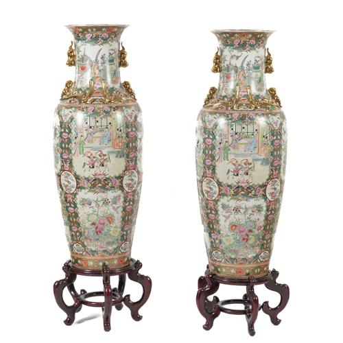 A PAIR OF CHINESE GILT-HEIGHTENED FAMILLE ROSE DECORATED LARGE BALUSTER VASES ON STANDS (4)