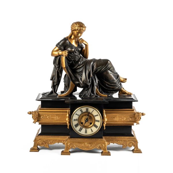 A GILT METAL MOUNTED AND BRONZE EFFECT NEOCLASSICAL REVIVAL MANTEL CLOCK