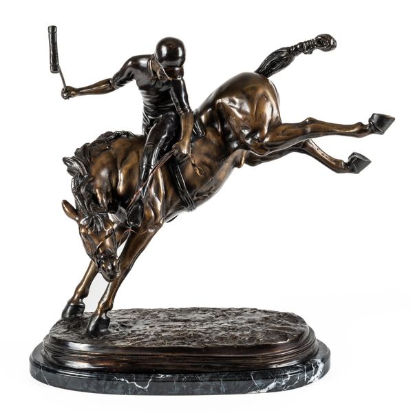 A BRONZE EFFECT CAST METAL FIGURE OF A POLO PLAYER