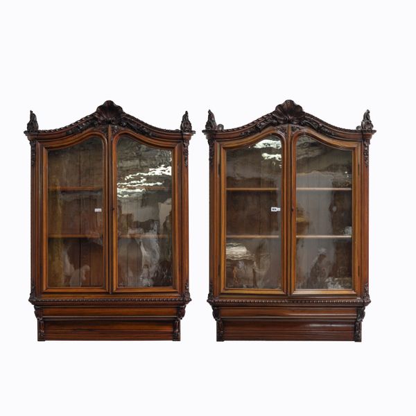 A PAIR OF CARVED WALNUT HANGING TWO DOOR DISPLAY CABINETS (2)