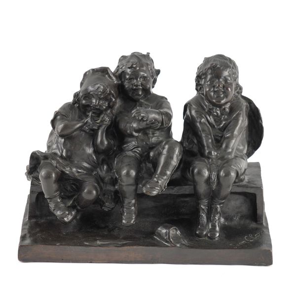 JUAN CLARA (SPANISH 1875-1957): A BRONZE GROUP OF THREE CHILDREN SITTING ON A BENCH