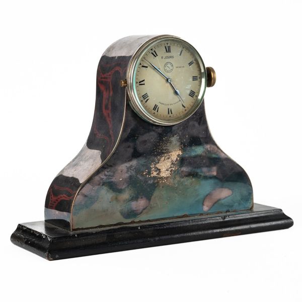 A EIGHT-DAY CAR CLOCK NOW IN A SILVER-PLATED ARCHED MANTEL CASE