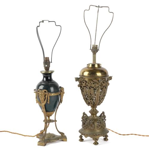A NEO-CLASSICAL STYLE GILT-METAL AND CERAMIC MOUNTED TRIFORM TABLE LAMP TOGETHER WITH ANOTHER PIERCED GILT METAL EXAMPLE (2)