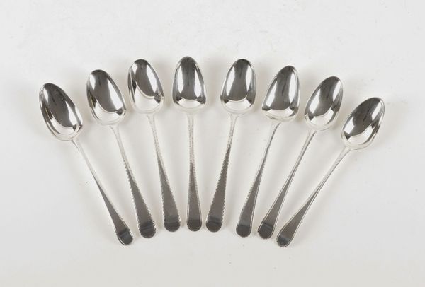 EIGHT SILVER FEATHER AND ENGRAVED EDGE SILVER DESSERT SPOONS (8)