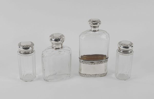 FOUR SILVER MOUNTED GLASS BOTTLES AND JARS