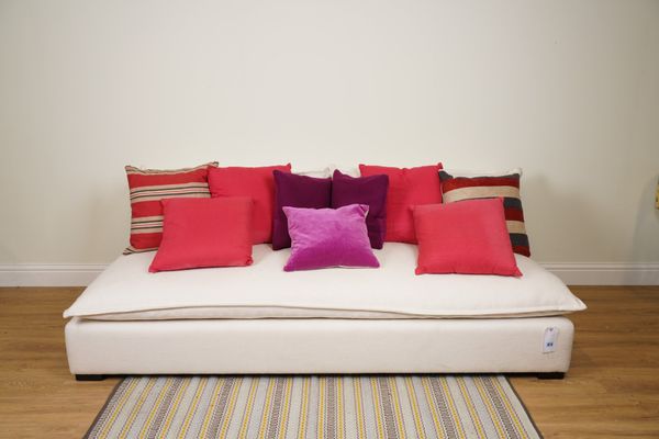 CUSHIONS, A GROUP OF NINE CUSHIONS IN PINKS AND PURPLES (9)