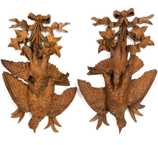 A PAIR OF 19TH CENTURY BLACK FOREST CARVED LIMEWOOD RIBBON-TIED FEATHERED GAME TROPHIES