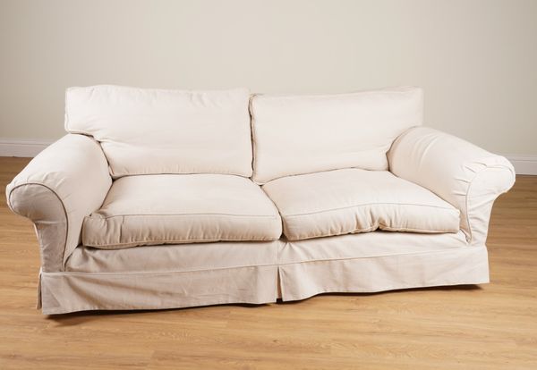 DURESTA; A DEEP SEAT SOFA WITH LOOSE CREAM COVERS