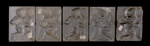 A SET OF FIVE ART DECO FROSTED AND MOULDED GLASS PANELS OF DANCING PUTTI WITH INSTRUMENTS