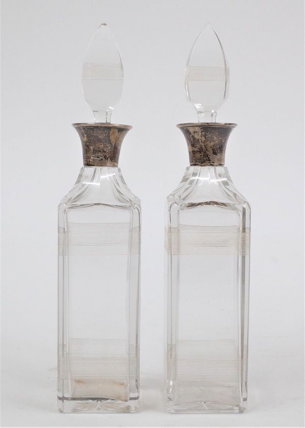 A PAIR OF SILVER MOUNTED GLASS BOTTLES AND STOPPERS